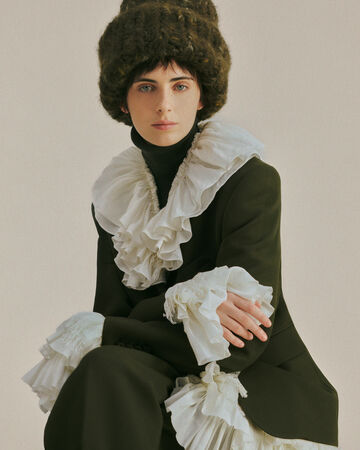 Model wearing white laces shirt and beanie from the Fall/Winter 2026 collection